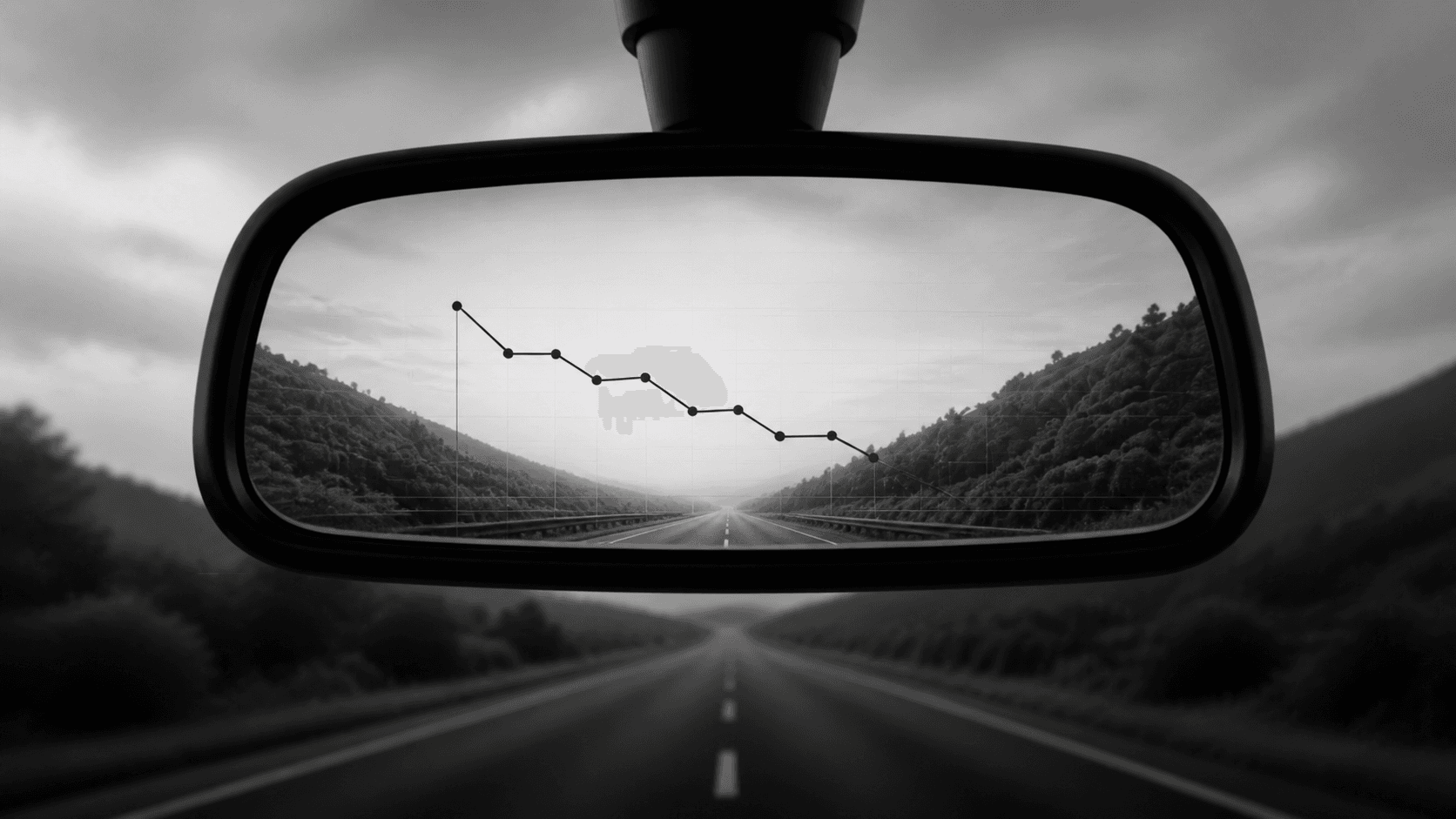 A rear-view mirror reflecting a declining report while the road falls behind
